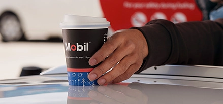 Picking up a Mobil takeaway coffee.